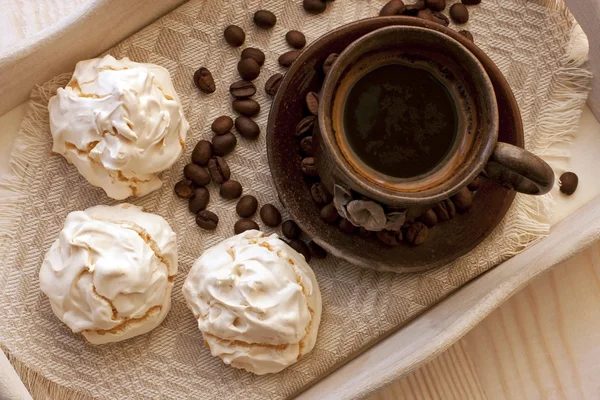 Meringue cookies and cup of aromatic coffee — Stock Photo, Image