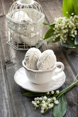 Bouquet of spring flowers lily of the valley with marshmallows