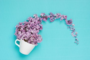 Leylak çiçekleri ve seramik kupa ile yaratıcı konsept, fotokopi alanı ile üst görünümü