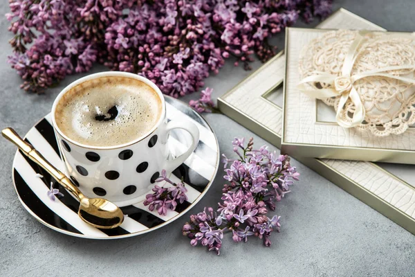 Romantic composition with lilac flowers, and coffee cup. Bridal or birthday conceptio