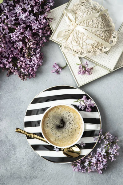 Romantic composition with lilac flowers, coffee mug  and  decorative heart, top view