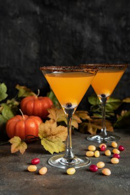 Pumpkin orange cocktail in glass. Fall Seasonal Drinks for Halloween party