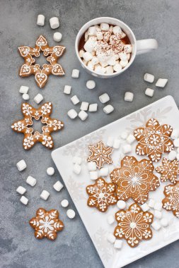 Cup of creamy hot chocolate with melted marshmallows and  gingerbread cookies   for christmas holiday, flat lay