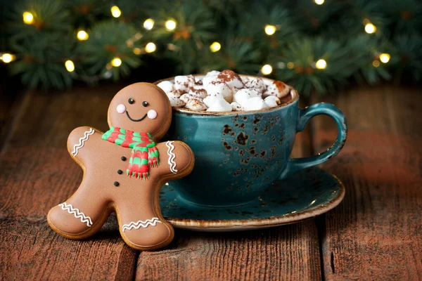 Cup of creamy hot chocolate with melted marshmallows and gingerbread cookies  for christmas holiday