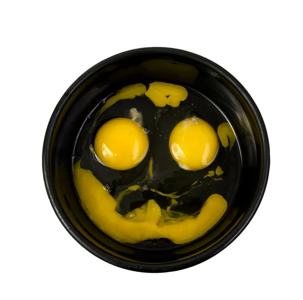 Smily face made with eggs yolk and white in black bowl. — Stock Photo, Image