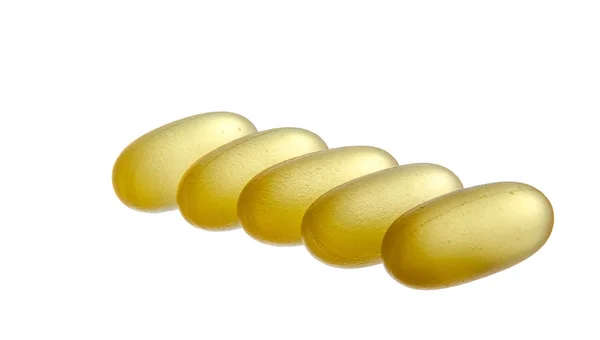 Píldoras amarillas semi-transparentes aisladas sobre fondo blanco —  Fotos de Stock