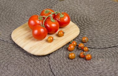 Fancy orange cherry tomatoes and red tomatoes on vine.