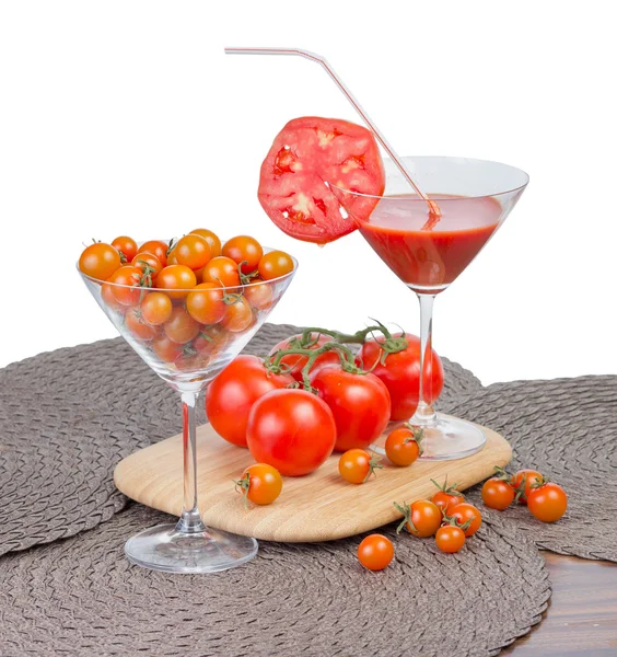 Tomatensap in het glas, oranje cherry tomaten en rode tomaten — Stockfoto