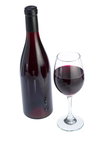 Glass full of red wine and bottle. — Stock Photo, Image