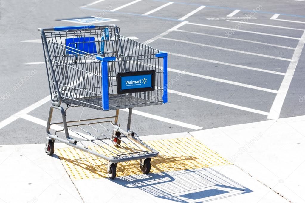 SACRAMENTO, USA - SEPTEMBER 13: Walmart shopping cart on September 13, 2013 in Sacramento, California. Walmart is an American multinational retail corporation that runs chains of large discount department stores