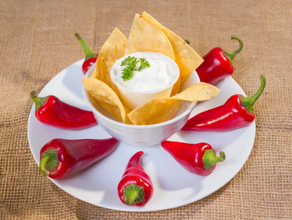 Crema agria con chips de maíz y pimientos rojos picantes . —  Fotos de Stock