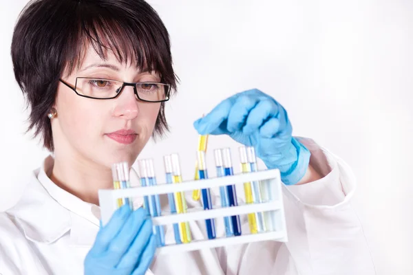 Picture of beautiful lab worker holding up test tube — Stock Photo, Image
