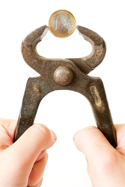 Hands compressing a coin with pliers — Stock Photo, Image