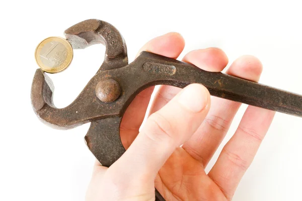 Hands compressing a coin with pliers — Stock Photo, Image