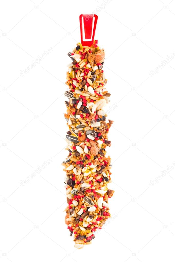 closeup of a birdseed bar on a white background