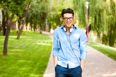 handsome man wlaking in the park on a sunny day