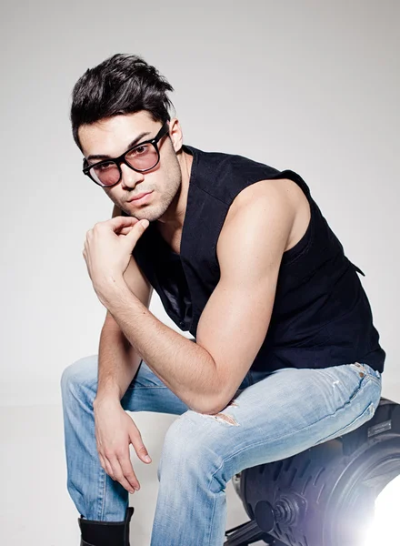 Sexy man doing a fashion photo shoot in a professional studio — Stock Photo, Image