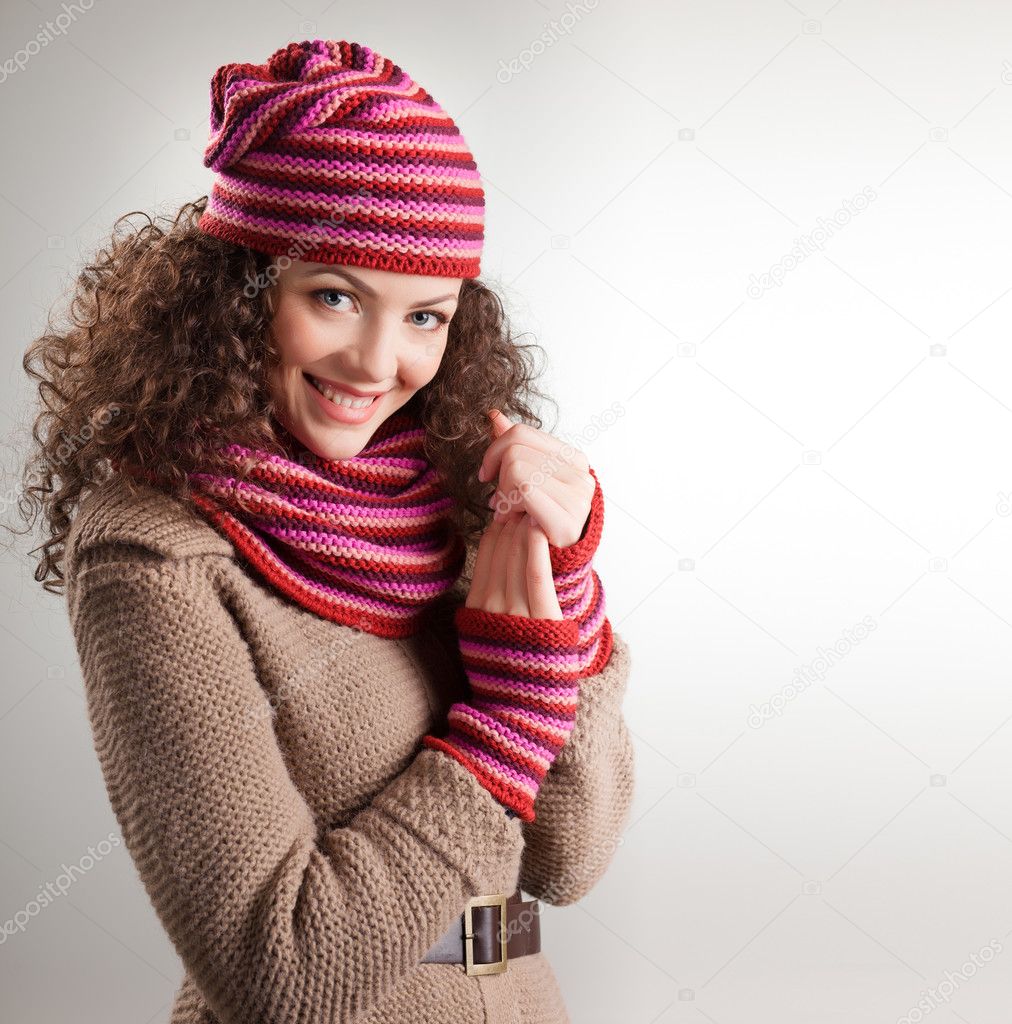 beautiful woman dressed in winter clothes smiling - studio shots