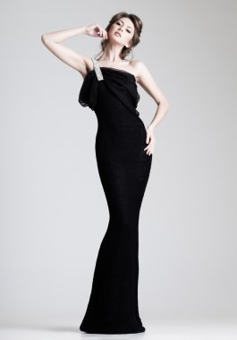 beautiful woman model posing in elegant dress in the studio clipart