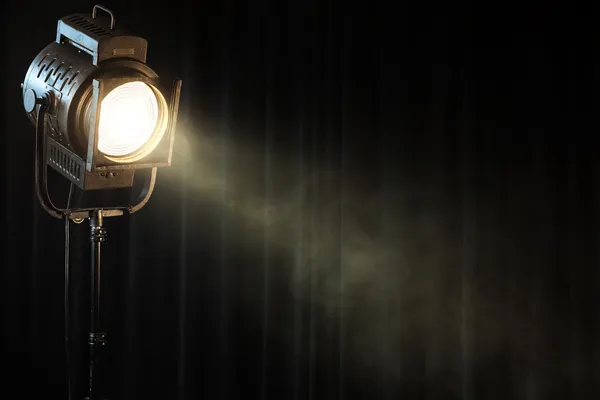 Vintage theatre spot light on black curtain with smoke — Stock Photo, Image