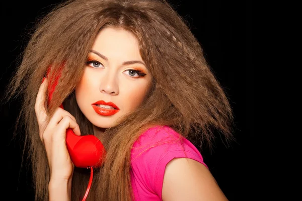 Hot sensual call girl talking on red telephone isolated on black — Stock Photo, Image