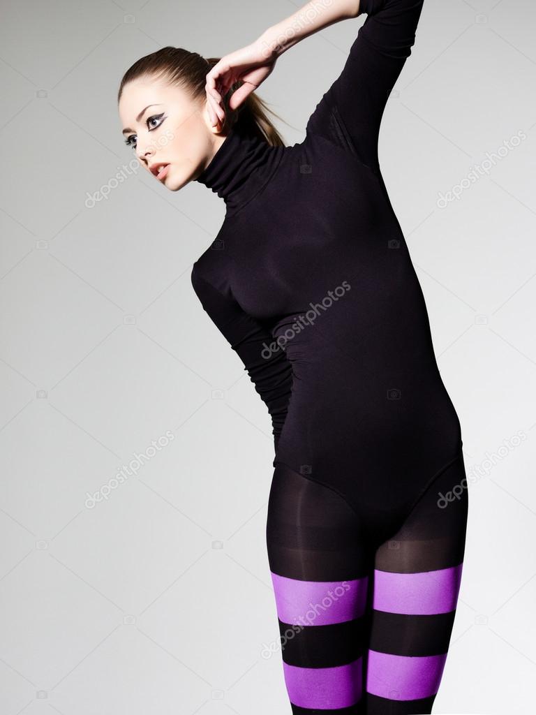 beautiful woman with perfect body dressed in purple striped tights and black top