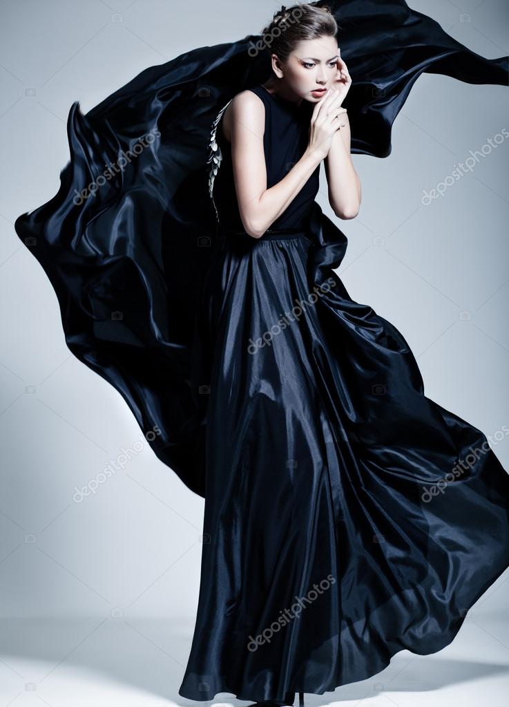 Elegant woman in blue ball gown dress standing and posing on a sunny  evening at city street. Fashion model full length portrait Stock Photo |  Adobe Stock