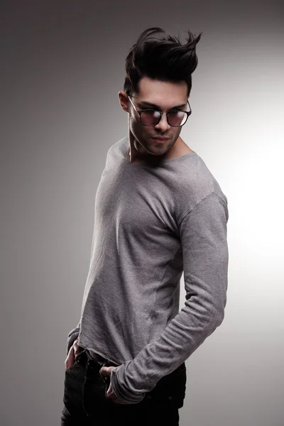 Sexy fashion man model dressed casual posing dramatic in the studio - low key — Stock Photo, Image