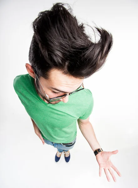 Funny man with wierd hairstyle showing his palm - wide angle shot — Stock Photo, Image