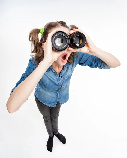 Linda chica divertida con dos colas de caballo mirando a través de lentes de fotos gran angular tiro — Foto de Stock