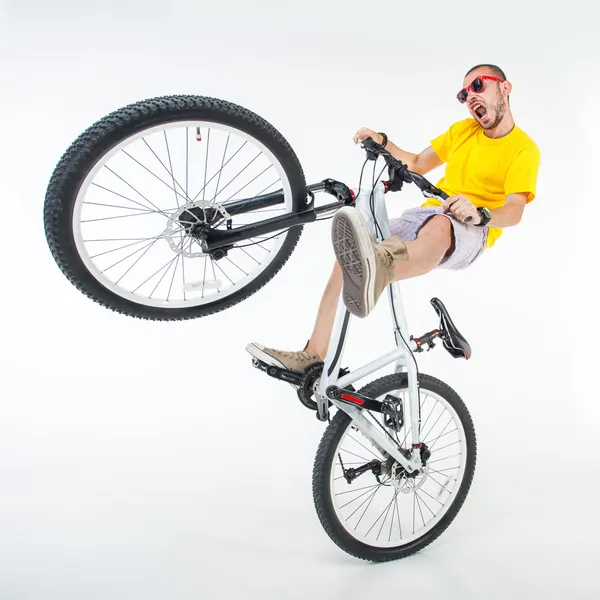 Crazy boy on a dirt jump bike isolated on white - wide studio sh — Stock Photo, Image