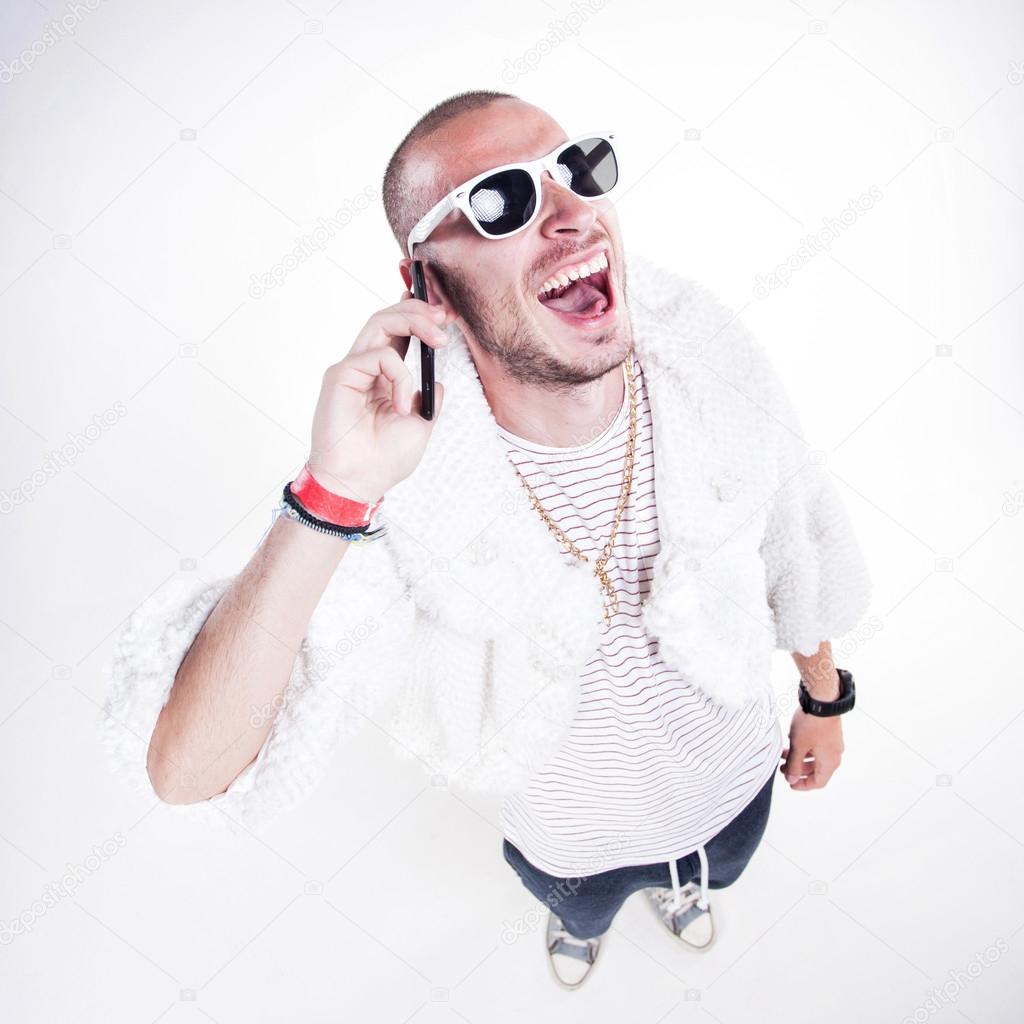 funny guy wearing fur and hipster glasses while laughing hard on the phone