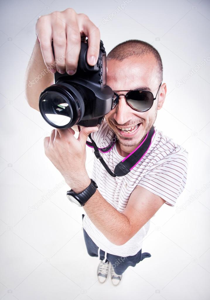 funny photographer posing with a camera smiling
