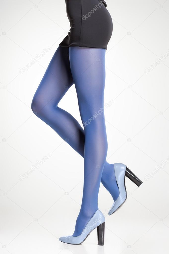 blue stockings on sexy woman legs isolated on grey