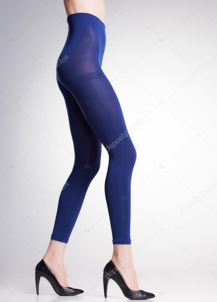 blue tights on sexy woman legs isolated on grey