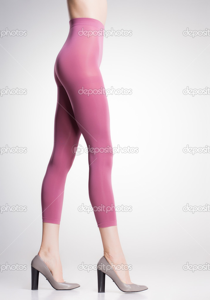 pink tights on sexy woman legs isolated on grey