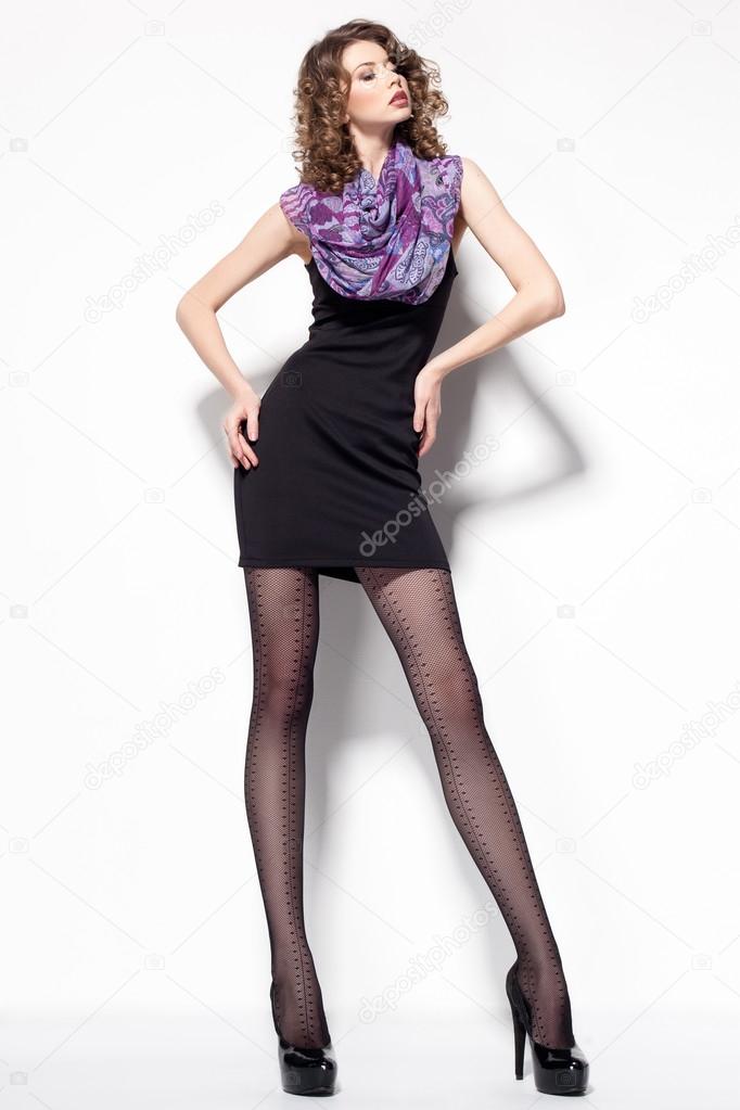 beautiful woman with long sexy legs dressed elegant posing in the studio - full body 