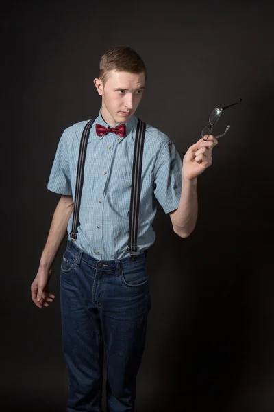 Man in a red suit and a bow tie plaid shirt on a black background — Stock Photo, Image