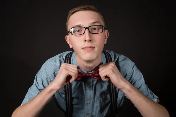 Man in a red suit and a bow tie plaid shirt on a black background — Stock Photo, Image