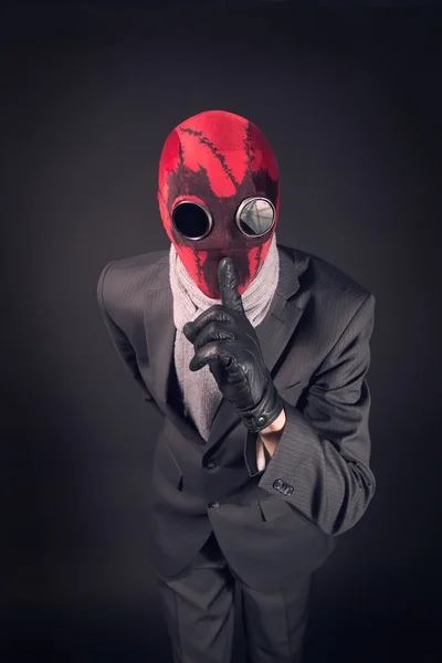 Man in a red mask handmade against the background of the destroyed city — Stock Photo, Image