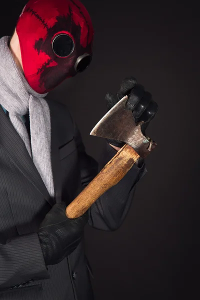 Man in a red mask handmade against the background of the destroyed city — Stock Photo, Image