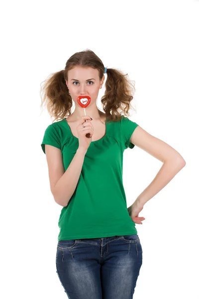 Closeup shot of girl with red heart lollipop isolated on white — Stock Photo, Image