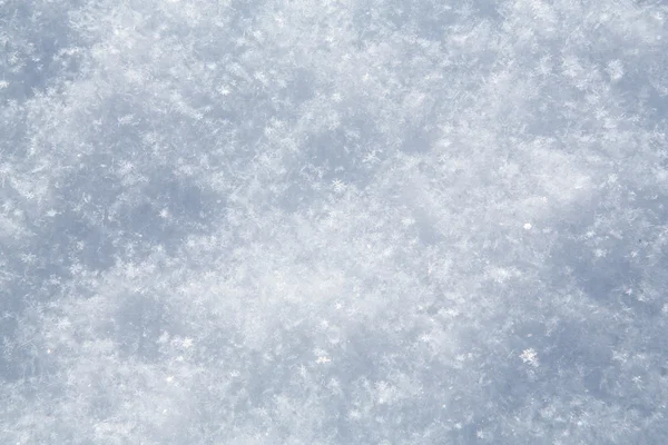 Bílá sněhové vločky pozadí, hrubý vzor sněhové textury — Stock fotografie