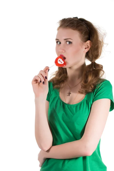 Closeup shot of girl with red heart lollipop isolated on white — Stock Photo, Image