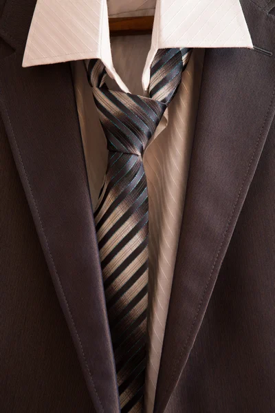 Business suit hanging on the rack in the wardrobe — Stock Photo, Image