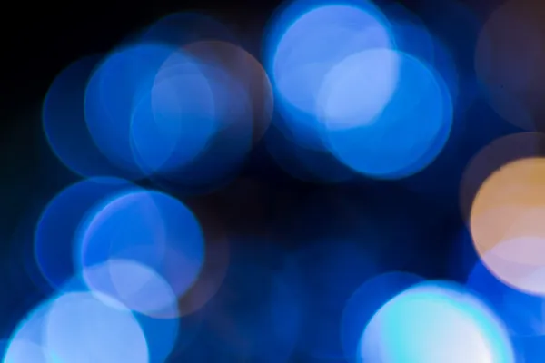 Foto de luces bokeh sobre fondo negro — Foto de Stock