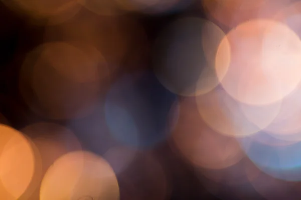 Foto de luces bokeh sobre fondo negro — Foto de Stock