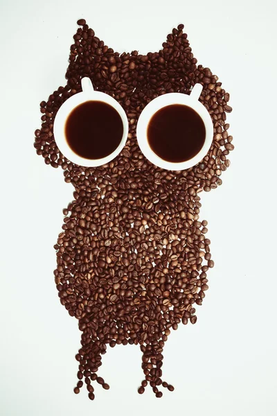 Conceptual owl made with coffee beans and cups — Stock Photo, Image