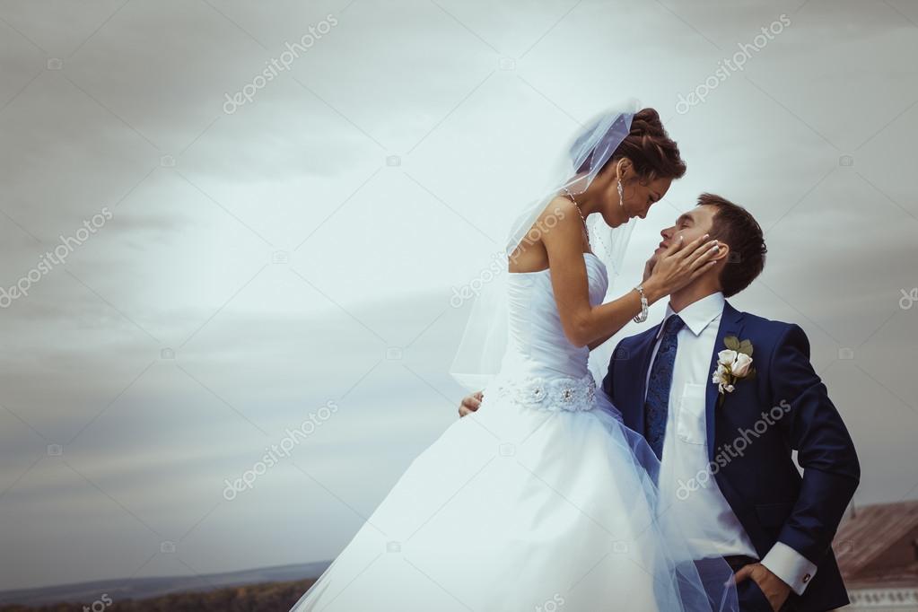 Young wedding couple kissing.