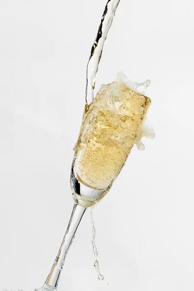 White wine splashing out of glass, isolated on white background — Stock Photo, Image